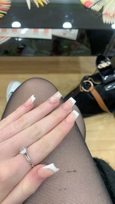 white french tips with silver glitter, two snowflakes on ring Aesthetic Nails Acrylic Winter, White French Tip With Snowflake On Ring Finger, White French Tips Christmas, Christmas Nail Inspo 2024, French Tips With Snowflakes Nails, Snow French Tip Nails, Christmas Nails Square Simple, Christmas Nails Acrylic Snowflake, Christmas Nails Matching