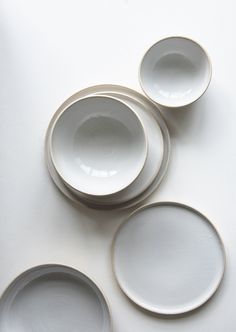 four white dishes sitting on top of each other