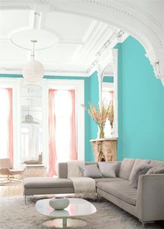 an elegant living room with blue walls and white carpeted flooring is pictured in this image