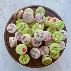 there are many decorated cookies in the bowl