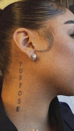 a woman with the word purpose written on her back side behind her ear and nose