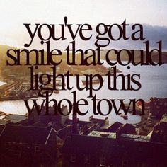 an image of a city skyline with the words you've got a smile that could light up this whole town