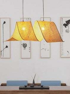 three lamps hanging over a dining room table