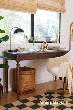 a desk with a chair, potted plants and a window