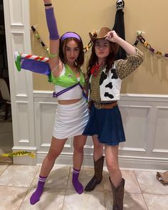 two girls dressed in costumes posing for the camera