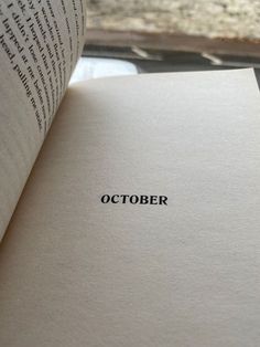 an open book with the word october printed on it