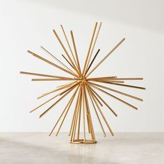 a sculpture made out of sticks sitting on top of a table