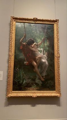 a painting hanging on the wall in a museum with a woman sitting on a swing