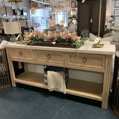 a table with flowers on it in a store