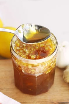 a spoon full of food sitting on top of a wooden table