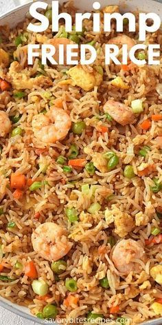 shrimp fried rice with peas and carrots in a pan on a white tablecloth