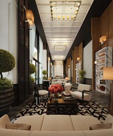 a living room filled with lots of furniture next to a tall window covered in plants