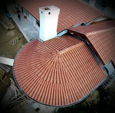 an aerial view of the roof of a building with a chimney in the center and two chimneys on each side