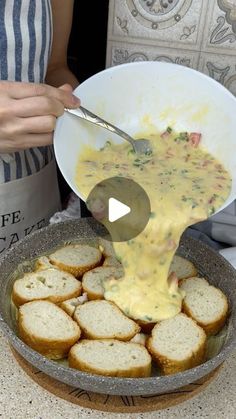 a person pouring cheese on bread in a bowl