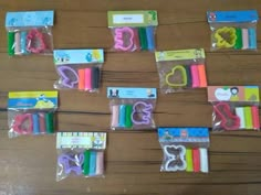 some school supplies are laid out on a wooden table with scissors and other items in plastic bags