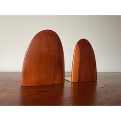 two wooden sculptures sitting on top of a wooden table