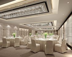 a large dining room with white chairs and tables