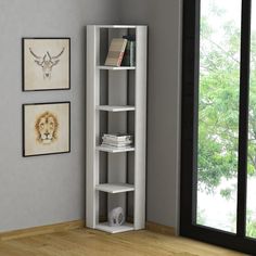 a corner shelf with books on it in front of a window and pictures hanging on the wall