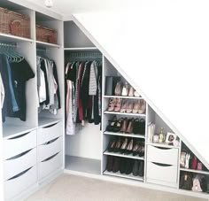 an organized closet under the stairs with shoes and other items on shelves in front of it