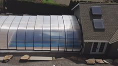 an aerial view of a house with solar panels on the roof