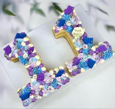 the letter h is decorated with flowers and beads