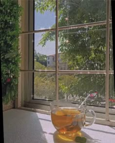 a cup of tea sitting on top of a window sill