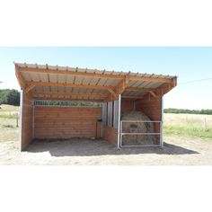 a horse stall with hay in the back