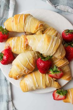 croissants and strawberries on a white plate