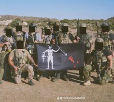 a group of soldiers holding up a black flag with an image of a skeleton on it