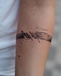 a woman's arm with an arrow tattoo on the left side of her arm