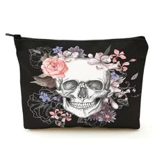 a skull with flowers and leaves on it's face is shown in this black cosmetic bag