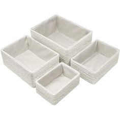 three white wicker baskets sitting on top of each other