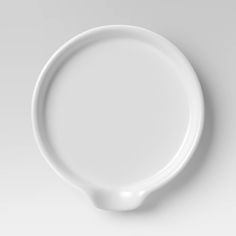 an empty white plate on a gray background