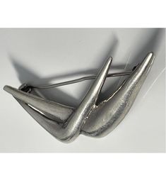 This is a lovely vintage sterling silver smooth abstract brooch.  It measures 6.2cm long and 1.8cm wide and it is stamped '925' on the back of the piece.  The brooch is made up of two curved 'v' shapes with a smooth exterior that catches the light beautifully.  The geometric shapes give the brooch a fabulous modernist feel and this is piece is in excellent condition.  It is one of many vintage, contemporary and antique items of jewellery that I am currently selling on Etsy. Please see my Etsy sh Abstract Brooch, Antique Items, Vintage Sterling Silver, Geometric Shapes, Brooch Pin, Brooches, Selling On Etsy, Etsy Shop, Sterling Silver