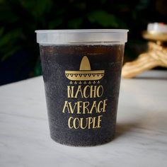 a plastic cup with the words nacho average couple on it sitting on a table