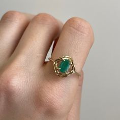 Estate/ vintage 14KT yellow gold oval, genuine emerald band ring. Super unique solitaire ring with an artistic, wavy double gold band setting. Size 9 Can be resized for an additional fee .75 carat medium green color oval emerald 7 mm x 6.75 mm Inclusions which is typical of a natural emerald Weight: 2.5 grams Mid century design Excellent Estate Condition Clearly Antique Style Oval 14k Gold Emerald Ring, Unique Yellow Gold Oval Emerald Ring, Modern Oval Emerald Ring In Yellow Gold, Unique Oval Emerald Ring In Yellow Gold, Oval Emerald Ring In Gold, Unique Oval Emerald Ring With Polished Finish, Gold Oval Emerald Ring, Gold Oval Emerald Ring With Prong Setting, Oval Gold Solitaire Emerald Ring