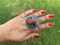 This listing is for 1 piece. At wholesale price Large Tibetan Rings with Turquoise, Coral & Lapis Inlay is absolutely stunning with beautiful adjustable band. You will receive the exact ring shown in the pictures.This high quality durable statement piece ring is handmade in Nepal. Beauty of this ring that is unmatched as they are handmade and are one of a kind. With the nature of them being handmade, each product is unique in its own right and no two products are the exact same. Made with Ti Adjustable Bohemian Crystal Ring, Bohemian Crystal Ring, Blue Bohemian Crystal Ring, Adjustable Multicolor Turquoise Bohemian Ring, Adjustable Bohemian Turquoise Ring With Stone Setting, Multicolor Natural Stones Turquoise Ring In Bohemian Style, Multicolor Natural Stones Turquoise Ring Bohemian Style, Multicolor Natural Stones Turquoise Bohemian Ring, Adjustable Bohemian Rings With Stones