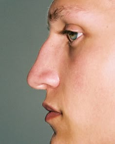 a close up of a person's face with one eye open and the other half closed