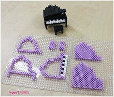 a lego crafting set with purple and white items on the table next to it