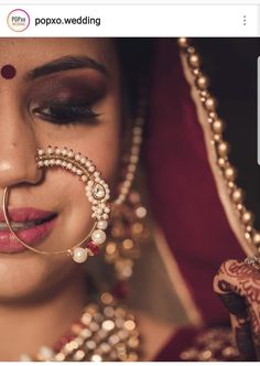 a woman with jewelry on her face and nose