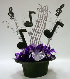 a green pot filled with musical notes and flowers