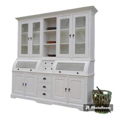 a white china cabinet with glass doors and drawers on the bottom, in front of a basket