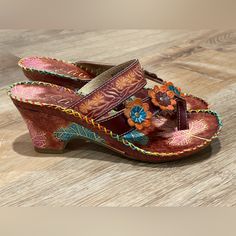 New Elite By Corkys Havana Slip On Toe Loop Floral Brown Sandal Size 7 Nwot / Nwob Step Into Warm Weather Style With The Help Of These Fun And Colorful "Summer" Sandals From Corky's Elite. Featuring A Leather Upper Decorated With Hand-Painted Floral And Leaf Designs, These Sandals Go Great With All Your Favorite Casual Summer Looks. Has A Padded Footbed Keeps You Comfy And Kicking. 3” Heel Hand-Painted / Floral / Embroidered / Bright / Statement / Travel / Summer / Beach / Vacation / Resort / Re Bohemian Open Toe Heels, Bohemian Heels For Vacation, Bohemian Multicolor Open Toe Heels, Brown Bohemian Heels For Spring, Bohemian Brown Heels For Spring, Bohemian Beach Heels, Traditional Multicolor Spring Heels, Traditional Multicolor Heels For Spring, Brown Sandals For Festival