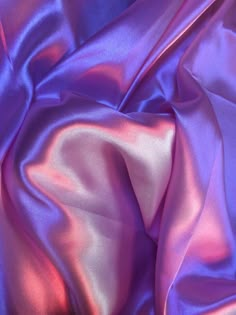 a close up view of a purple satin fabric