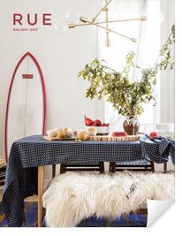 a dining room with a surfboard on the wall