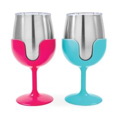 two wine glasses sitting next to each other on a white surface, one with blue and the other pink