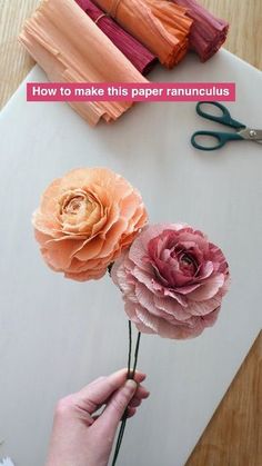 paper flowers being made with scissors and yarn