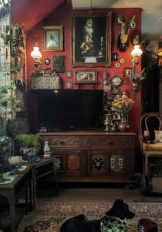 a living room filled with lots of furniture and pictures on the wall above it's tv