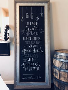 a framed chalkboard with the words let your light shine