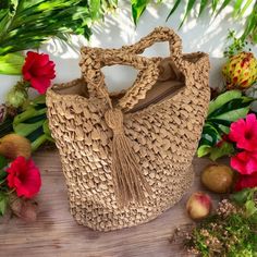 This lightweight natural straw handbag is expertly hand-woven and includes a tassel, inner zip pockets and zip closure. Measuring approximately 12" tall and 11" high, this bag also features a fabric lining on the inside. Natural Handwoven Straw Approximate Size: 12 inches Tall by 11 inches wide Zip Closure Color: Natural Beige Crochet Bag With Tassels For Travel, Casual Natural Bags With Fringe, Travel Straw Shoulder Bag With Fringe, Travel Shoulder Straw Bag With Fringe, Beige Tassel Bucket Bag For Vacation, Casual Brown Straw Bag With Fringe, Beige Straw Bag With Tassels For Travel, Natural Bags With Tassels For Spring, Spring Natural Bag With Tassels